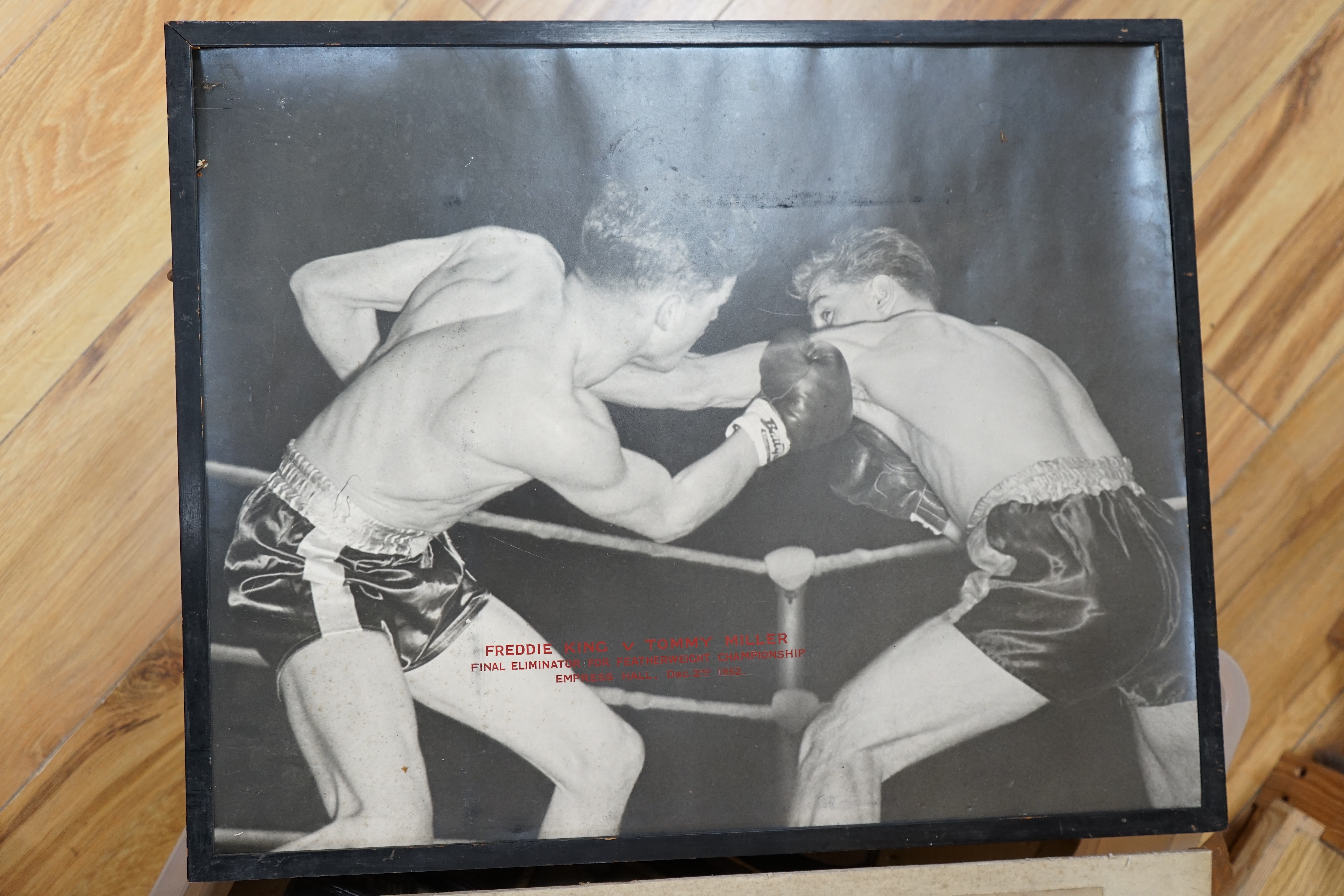 A collection of Jack Solomans boxing promo ephemera to include a shield shaped plaque, black and white photographs, books and a pastel portrait. Condition - varies